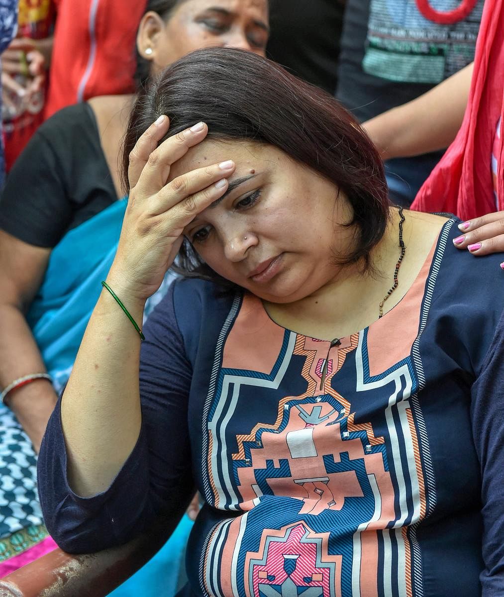 Kalpana, wife of Vivek Tiwari, who was shot by a police constable on patrol duty, mourns his death, in Lucknow on Saturday. PTI