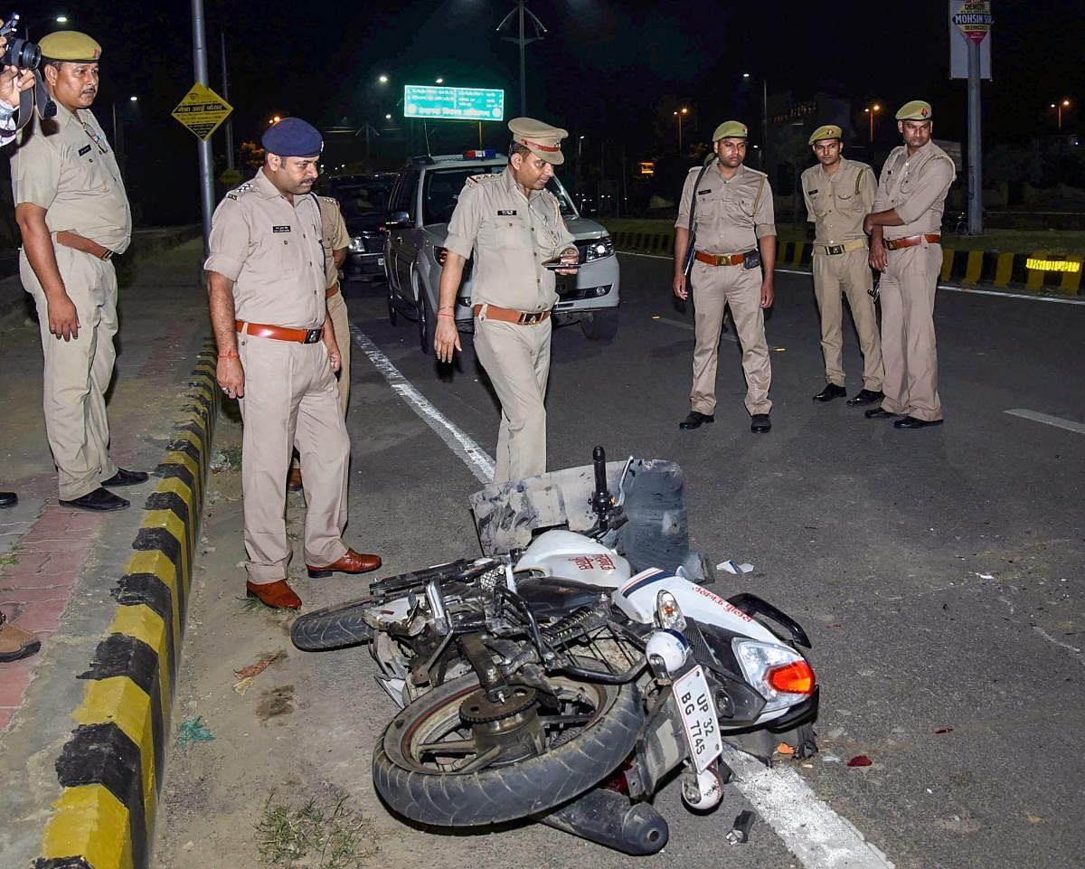 Police personnel conduct investigation near the bike of the constable responsible for shooting an Apple employee, on patrol duty, in Lucknow, on September 29. Tiwari was shot dead after he allegedly refused to stop his car for checking in the posh Gomti N