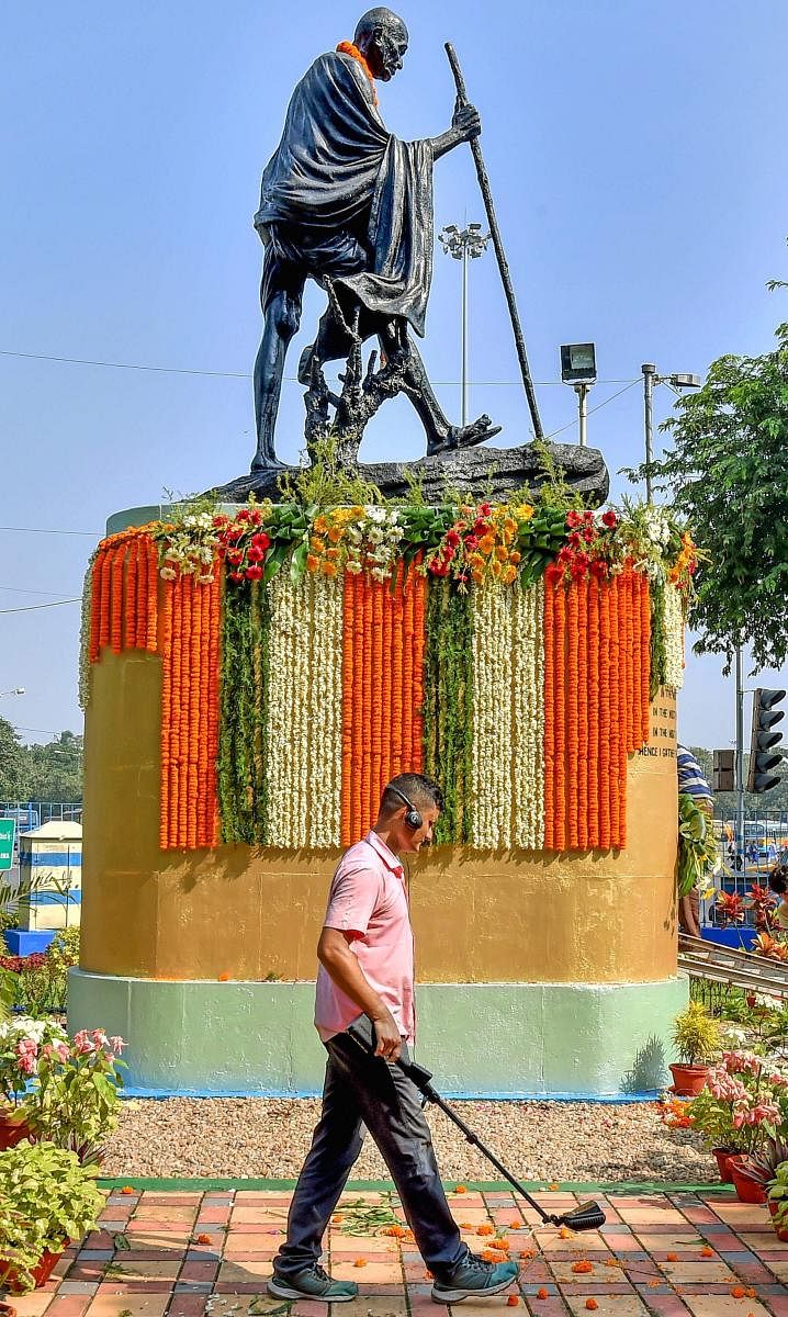 A security person inspects the area surrounding the Gandhi statue during the 149th birth anniversary of Mahatma Gandhi in Kolkata on October 2, 2018. PTI
