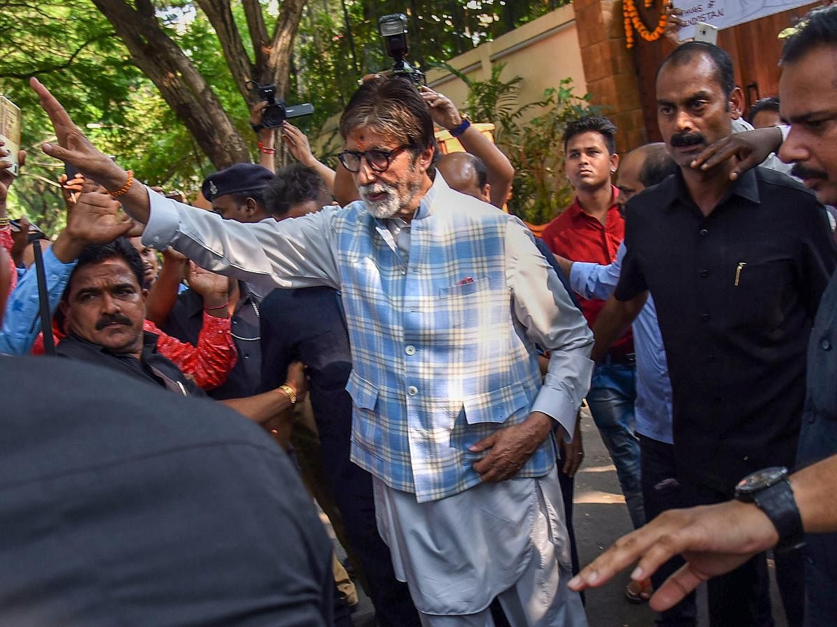 Bollywood actor Amitabh Bachchan greets fans who had gathered outside his bungalow on his 76th birthday, in Mumbai on Thursday. PTI