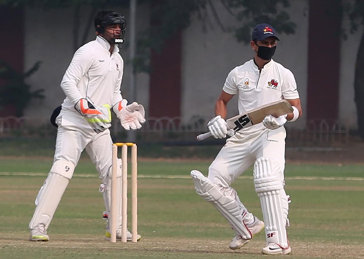 Mumbai’s Siddesh Lad bats with a mask to fight Delhi’s smog on the first day of the Ranji Trophy match against Railways in Delhi on Thursday. AFP