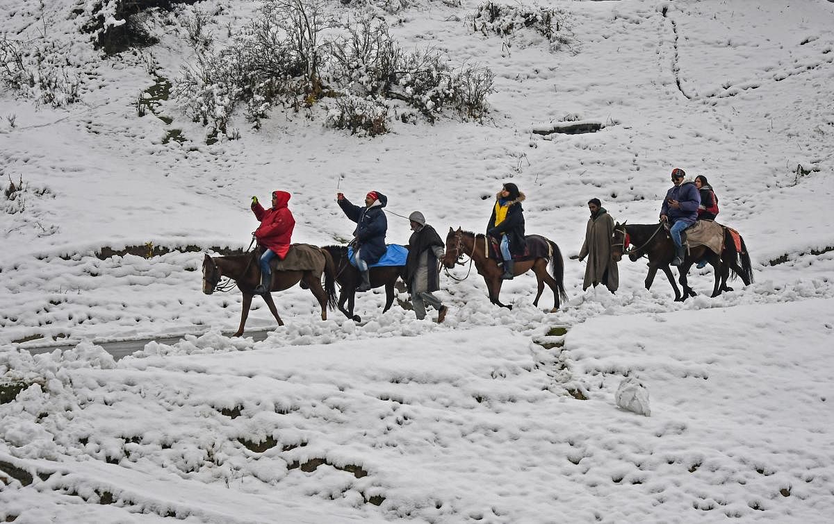 Gulmarg: Tourists enjoy horse ride after seasons first snow fall at famous ski resort of Gulmarg, in Distrct Baramulla of North Kashmir, Friday, November 2, 2018.( PTI Photo/S Irfan)(PTI11_2_2018_000140B)
