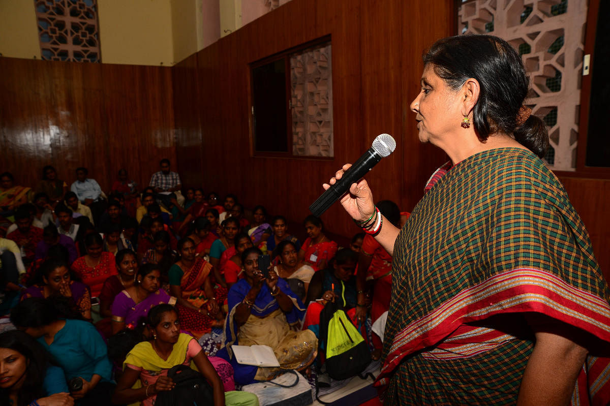 Activist Geeta Menon addresses garment and municipal workers at a #MeToo dialogue at the Kannada Bhavan in Bengaluru on Saturday. DH PHOTO