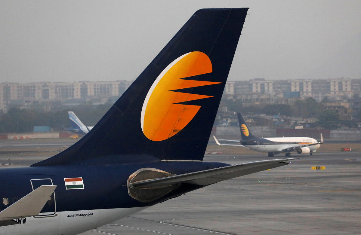 FILE PHOTO: A Jet Airways plane is parked as other moves to runway at the Chhatrapati Shivaji International airport in Mumbai, India, February 14, 2018. REUTERS