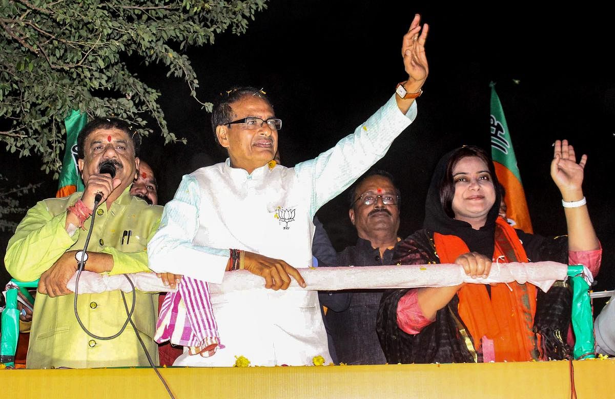 Madhya Pradesh Chief Minister Shivraj Singh Chouhan at a roadshow in support of BJP candidate from Bhopal North assembly constitutency Fatima Rasool Siddiqui (R) for State Assembly election, in Bhopal. PTI Photo 