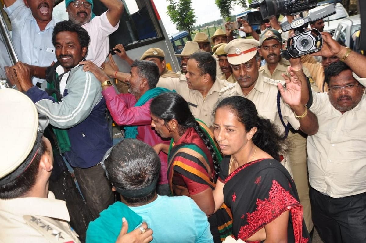 Farmers taken into custody for staging a protest against the Chief Minister H D Kumaraswamy at V C Farm, Mandya, on Friday.