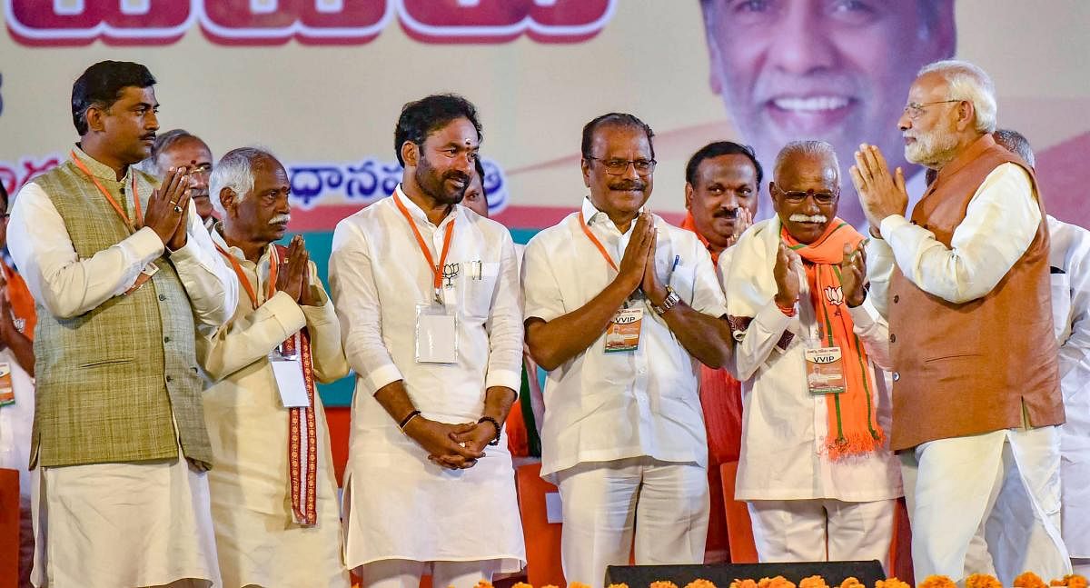 Prime Minister Narendra Modi greets his party leaders during a BJP election campaign ahead of the state Assembly elections at LB Stadium, in Hyderabad. PTI