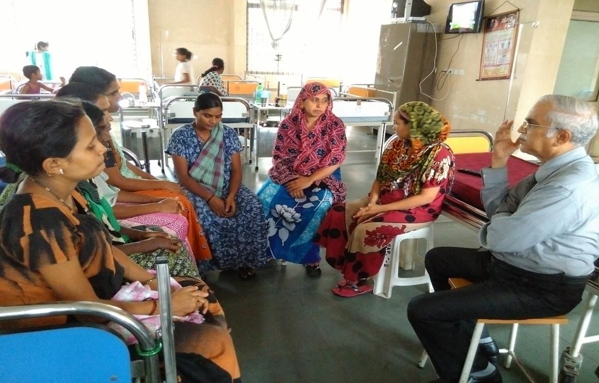 DK District Early Intervention Centre (DEIC) Nodal Officer Dr U V Shenoy interacts with young mothers on nutritional aspects at Lady Goschen Hospital in Mangaluru.