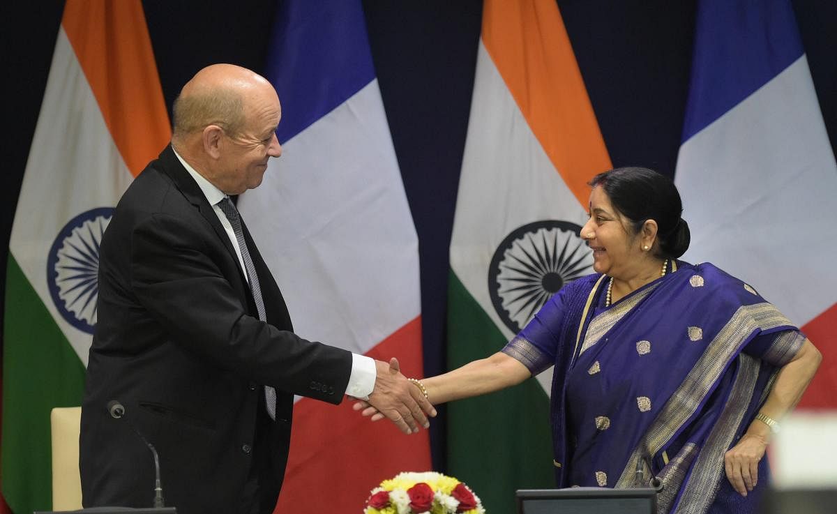 External Affairs Minister Sushma Swaraj and Minister of Europe and Foreign Affairs of France Jean-Yves Le Drian exchange greetings after their joint press statement in New Delhi on Saturday. PTI