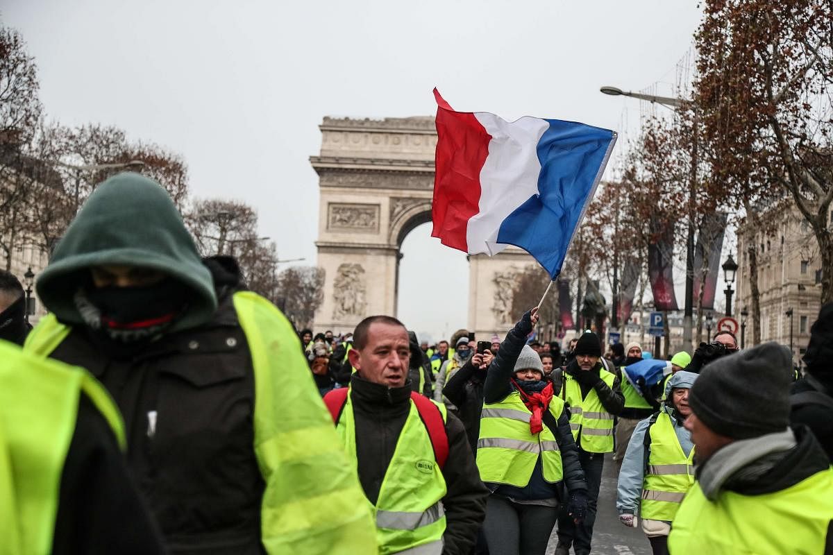 President Emmanuel Macron, facing the biggest crisis of his presidency, announced a series of concessions on Monday to defuse the explosive "yellow vest" movement which sprang up in rural and small-town France last month. (AFP Photo)