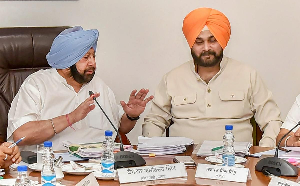 Punjab Chief Minister Captain Amarinder Singh with his Cabinet colleague Navjot Singh Sidhu during a Cabinet meeting in Chandigarh on Tuesday.
