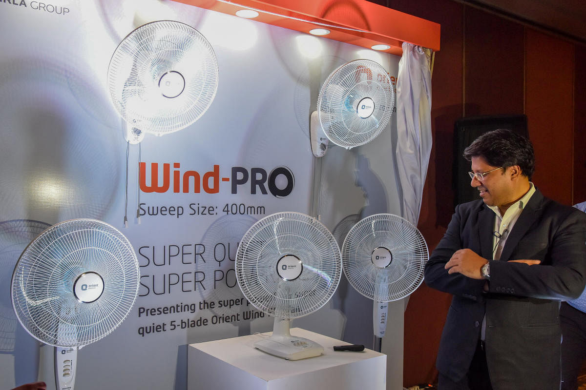Atul Jain presents Orient's new Wind-Pro portable fan series in Bengaluru on Wednesday. DH Photo