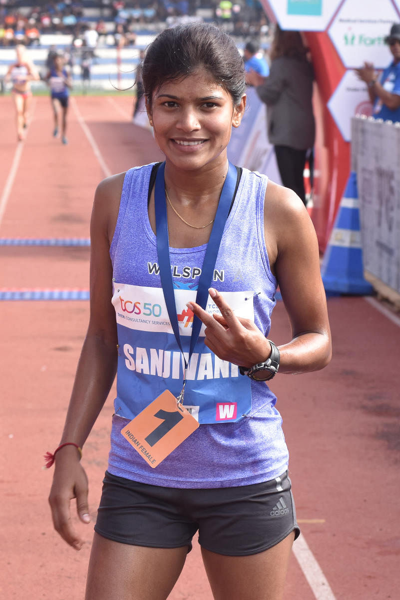 Sanjivani Jadhav showing victory sign after finish the Indian Elite Women10K run, organised by Procam International Private Limited at Kanteerava Stadium in Bengaluru on Sunday. Photo by S K Dinesh