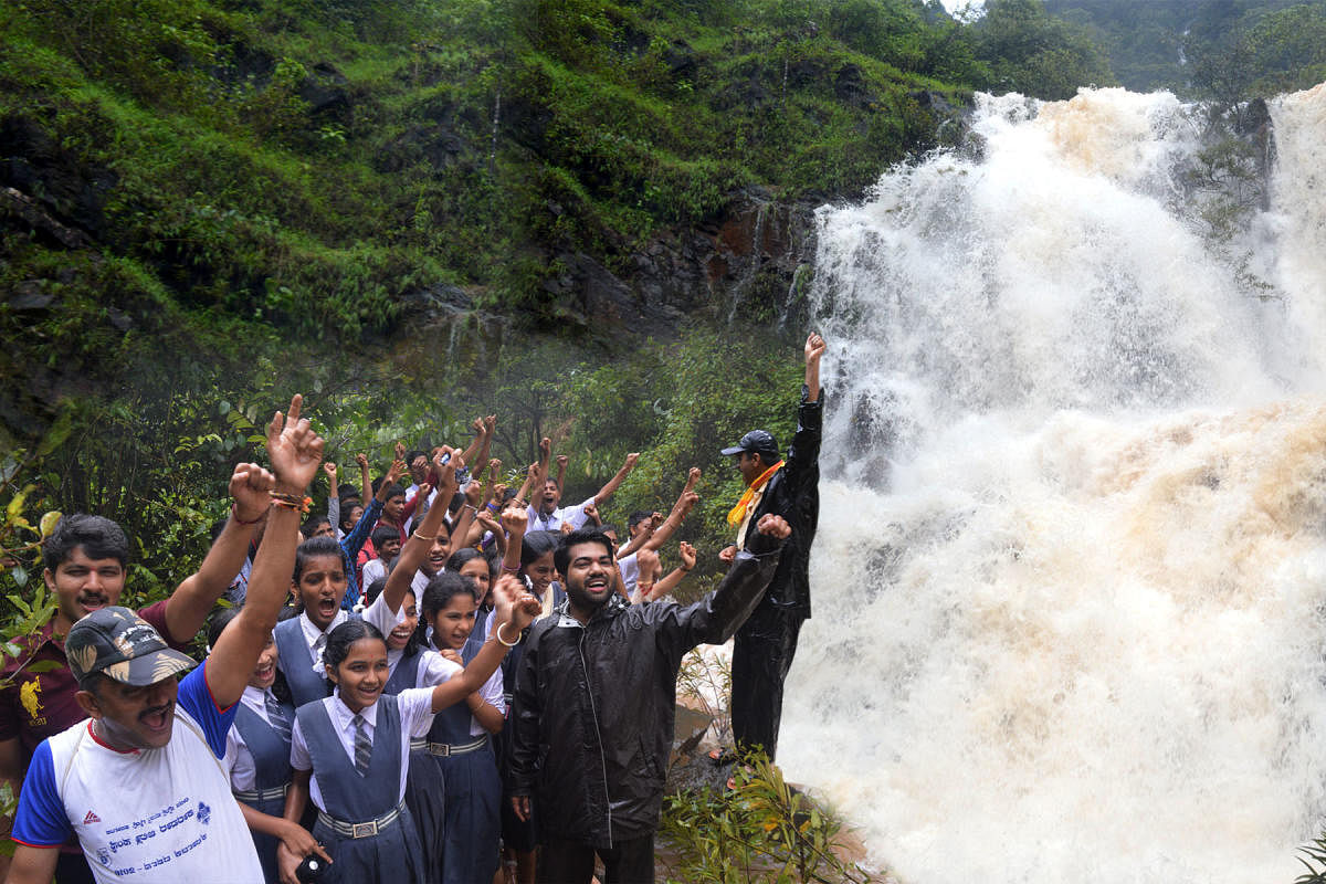 A group of students enjoys the beauty of Bangara Kusuma Falls near Gerusoppa in Honnavar taluk of Uttara Kannada district, which has come to life due to good rain in the region.