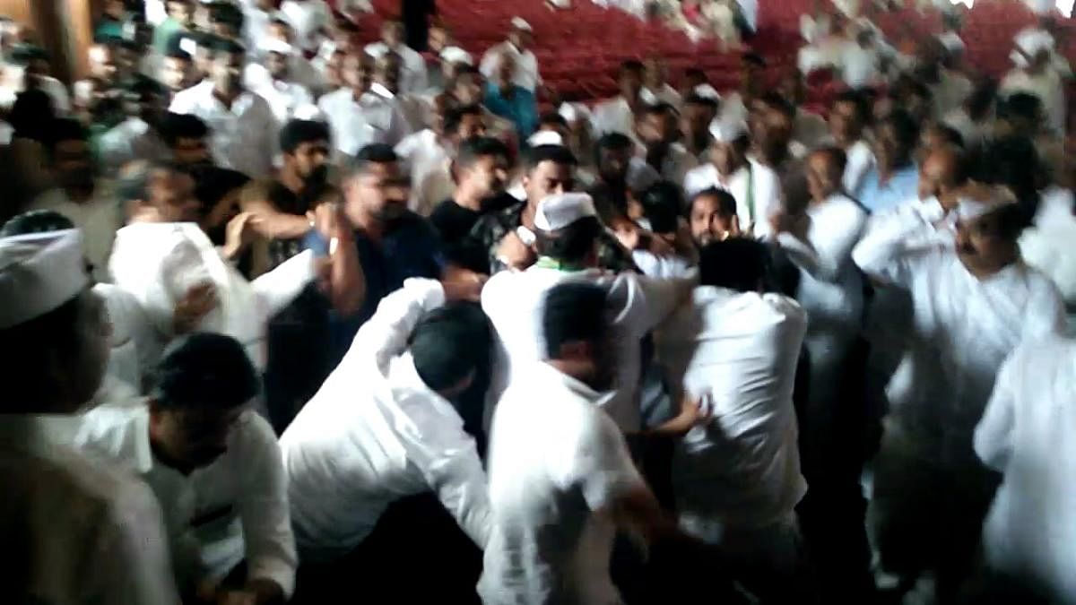 Two groups of Congress workers rough up each other at the end of a commemoration function of Quit India Movement at Town Hall in Mangaluru on Thursday.