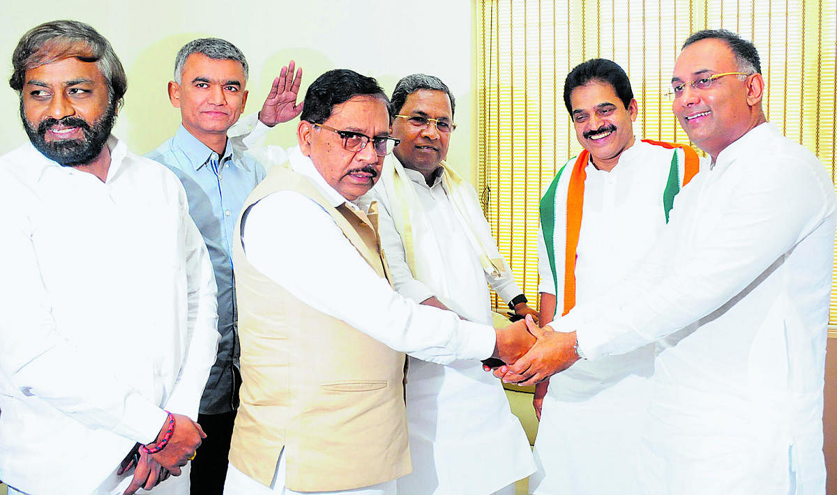 KPCC president Dinesh Gundu Rao greets Deputy Chief Minister G Parameshwara and former chief minister Siddaramaiah at the KPCC office in Bengaluru on Tuesday. (From left) KPCC working president Eshwar Khandre, Rural Development, Law and Parliamentary Affa