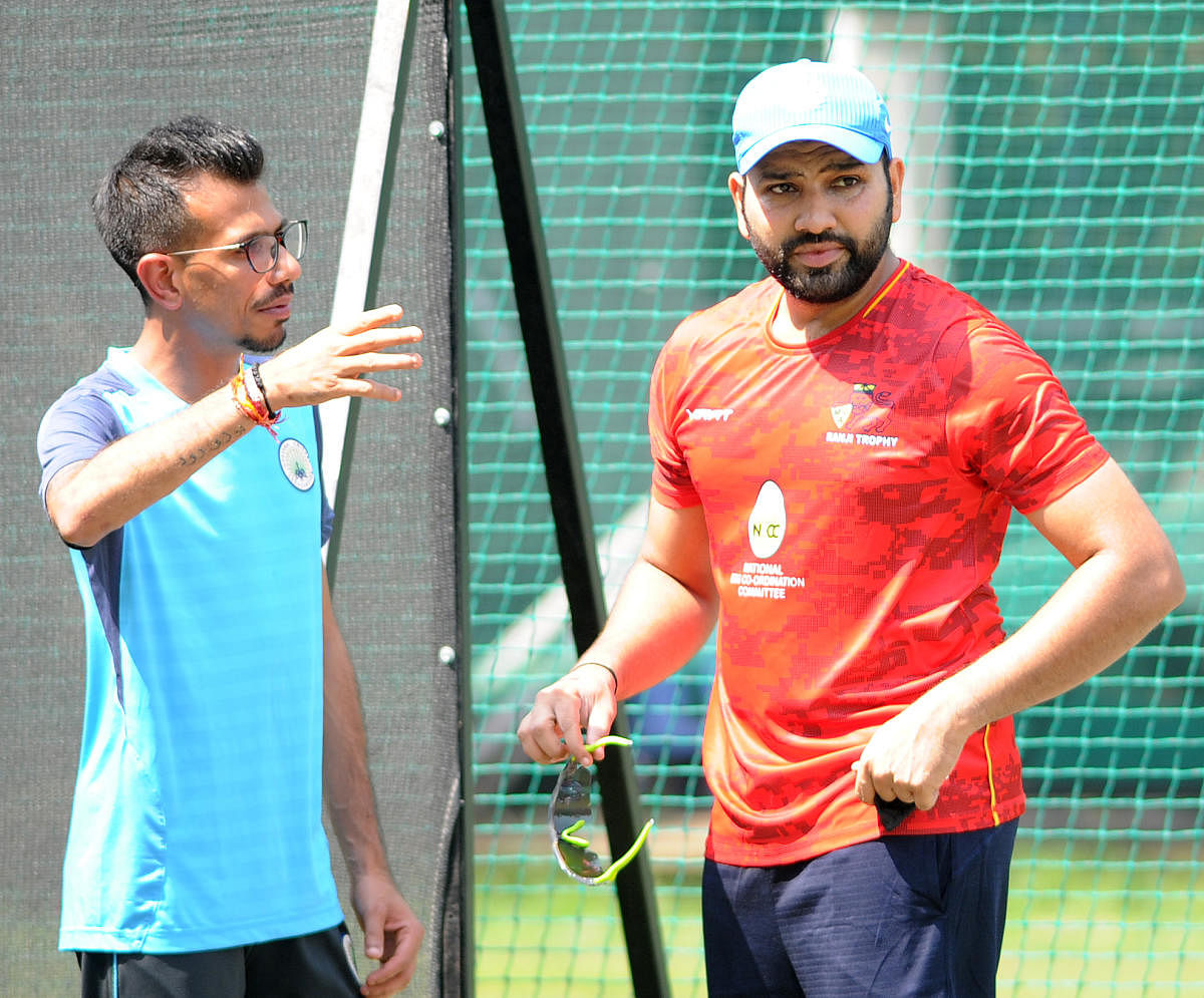 Mumbai's Rohit Sharma (right) and Haryana's Yuzvendra Chahal discuss a point during a practice session at the Chinnaswamy Stadium on Saturday. DH PHOTO/ SRIKANTA SHARMA R