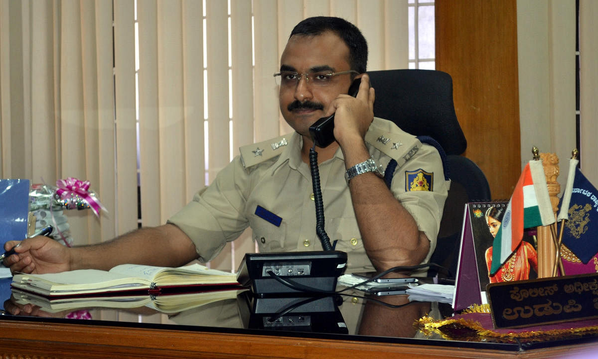 Superintendent of Police Lakshman Nimbargi receives a call during the weekly phone in programme in Udupi on Friday. 