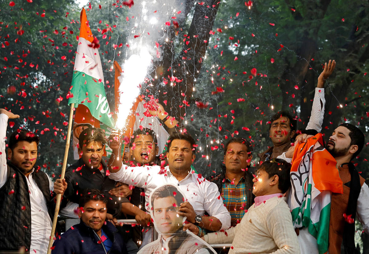 Supporters of India's main opposition Congress party celebrate after initial poll results at the party headquarters in New Delhi. REUTERS