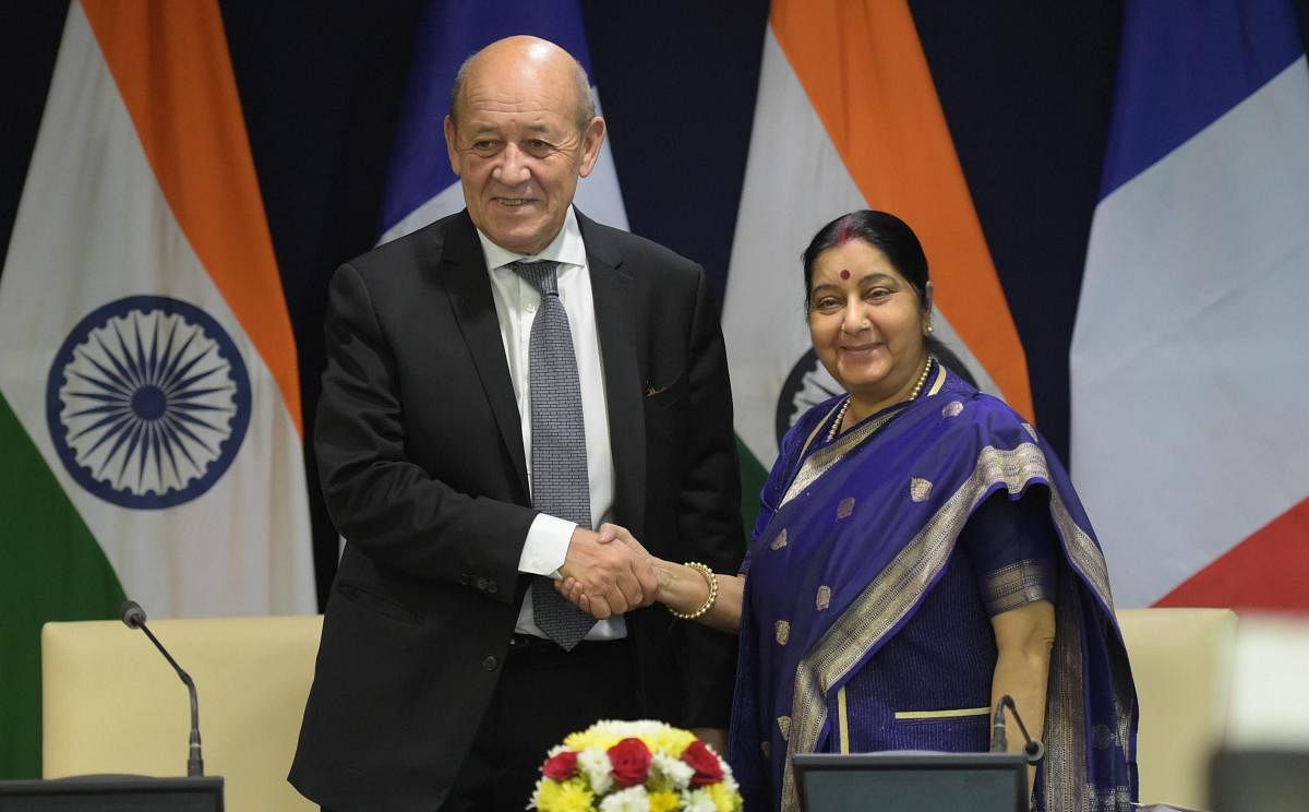 External Affairs Minister Sushma Swaraj and Minister of Europe and Foreign Affairs of France Jean-Yves Le Drian exchange greetings after their joint press statement in New Delhi on Saturday. PTI
