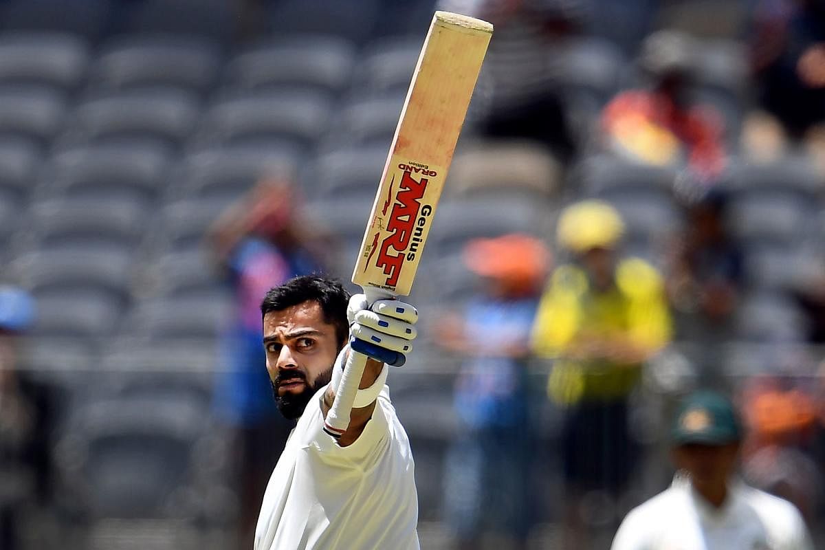 Virat Kohli celebrates after scoring his century against Australia on the third day of the second cricket Test match in Perth. AFP.