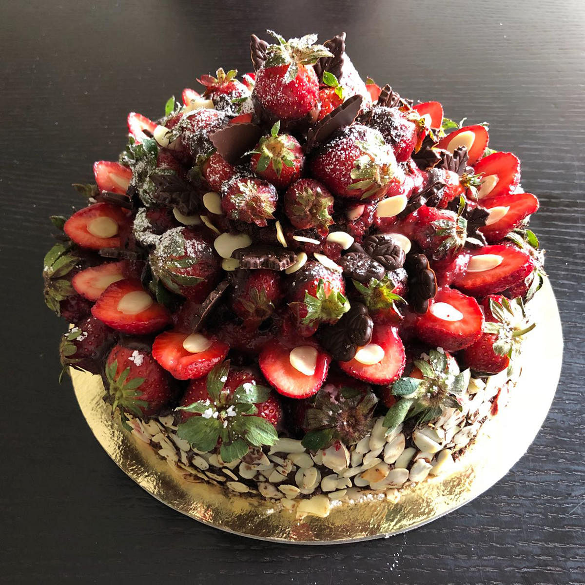 A chocolate, nuts and strawberry cake.
