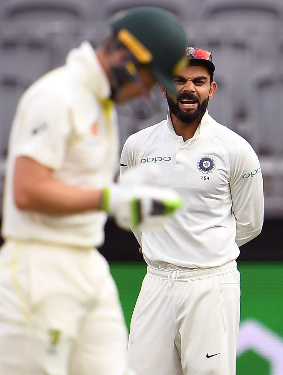 Virat Kohli has some words to say to his Australian counterpart Tim Paine in Perth on Sunday. AFP