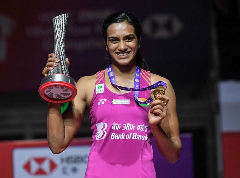 Winner PV Sindhu of India poses with her trophy after the women's singles final match at the 2018 BWF World Tour Finals badminton competition in Guangzhou in southern China. AFP Photo 