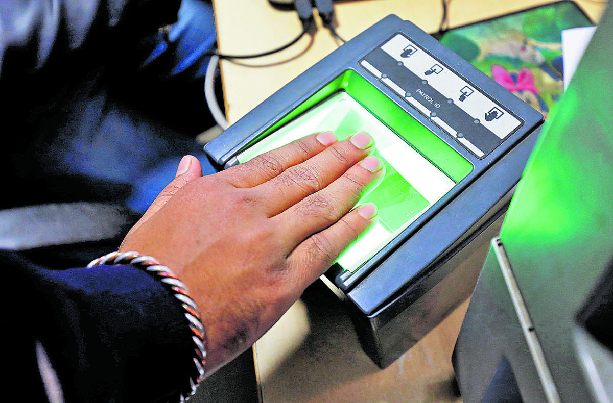 People giving their biometrics at an Aadhaar enrolment centre in Bengaluru.