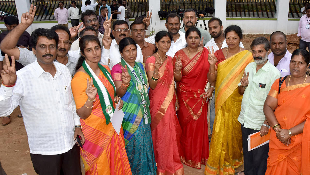 JDS winning candidates celebrating during the MCC election counting at New Maharani's in Mysuru on Monday.