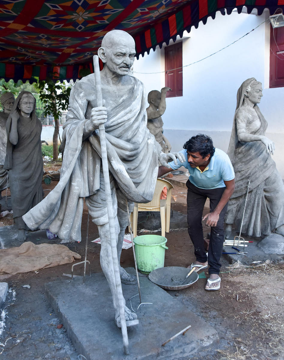 An artist works on a cement sculpture of Mahatma Gandhi during the camp organised as part of Gandhi’s 150th birth anniversary at Gandhi Bhavan, University of Mysore, in Mysuru, on Saturday.