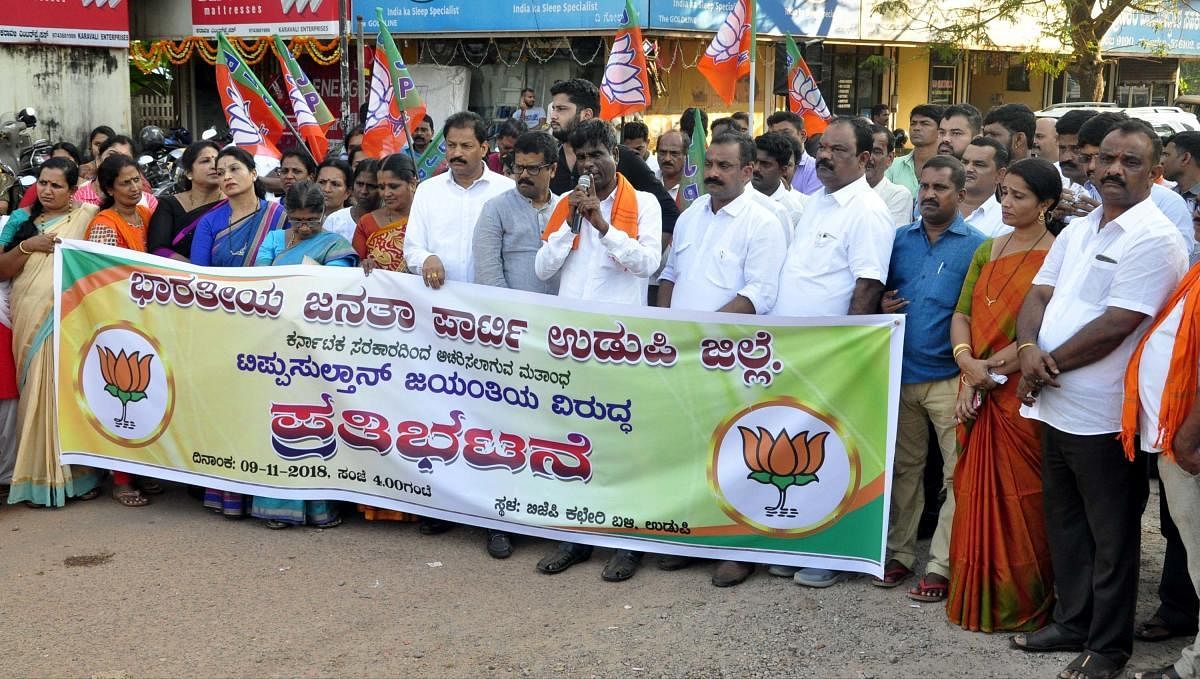 Leader of Opposition in the Legislative Council Kota Srinivas Poojary addresses protesters during BJP’s protest against Tipu Jayanti in Udupi on Friday. 