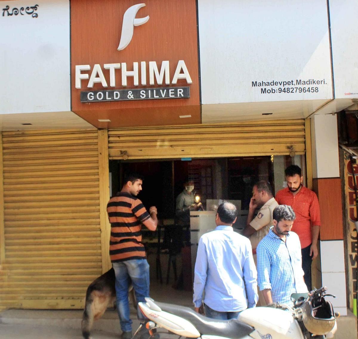 A dog squad and fingerprint experts inspect 'Fathima Gold and Silver' jewellery shop in Madikeri.