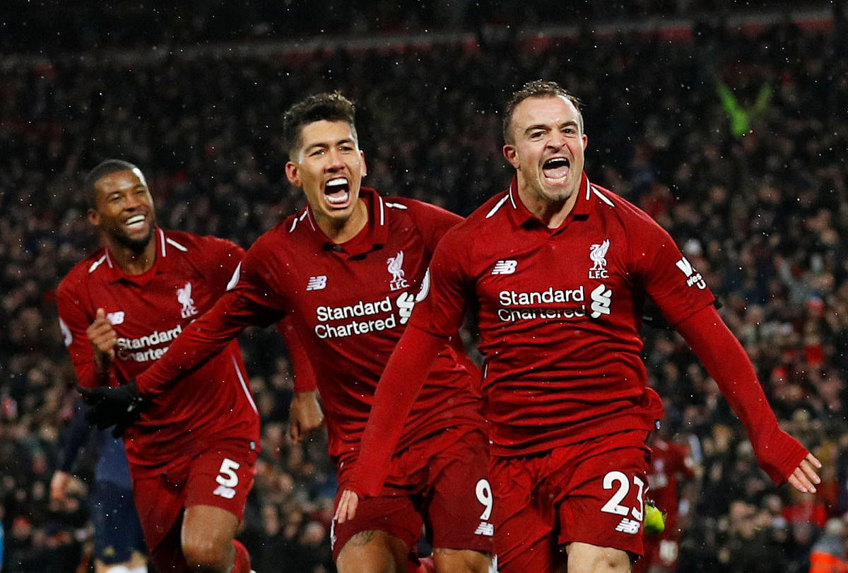 Liverpool's Xherdan Shaqiri celebrates with team-mates Roberto Firmino (centre) and Georginio Wijnaldum after scoring against Manchester United on Sunday. REUTERS