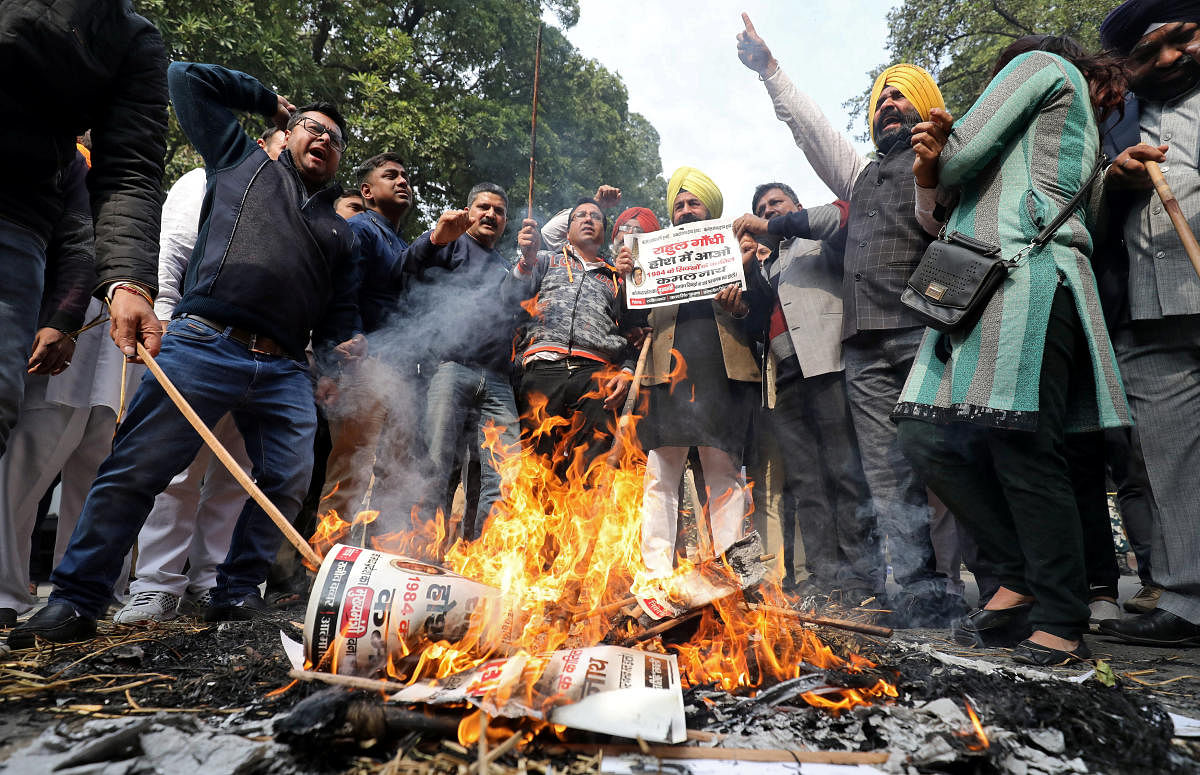 People burn placards and effigies of India's main opposition Congress party's leaders Sajjan Kumar and Kamal Nath during a protest near Congress party's headquarters in New Delhi, India, December 17, 2018. REUTERS