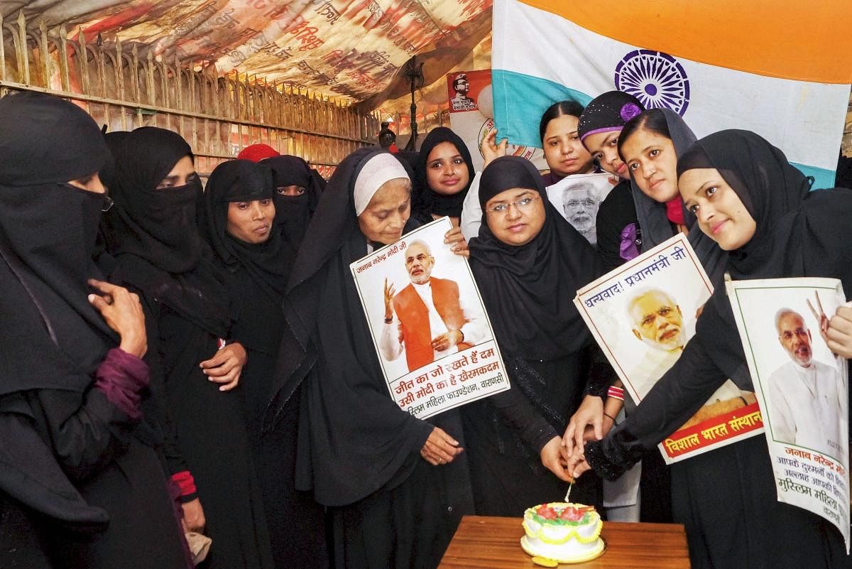 Muslim women cut a cake ahead of Prime Minister Narendra Modi's birthday, in Varanasi. PTI Photo