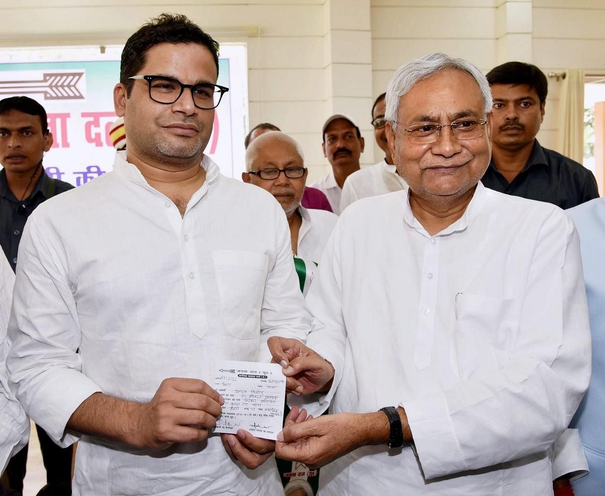 Bihar Chief Minister and Janta Dal United JD(U) National President Nitish Kumar greets electoral strategist Prashant Kishor after he joined JD(U) during party's state executive meeting at Anne Marg, in Patna, Sunday, Sept 16, 2018. (PTI Photo)