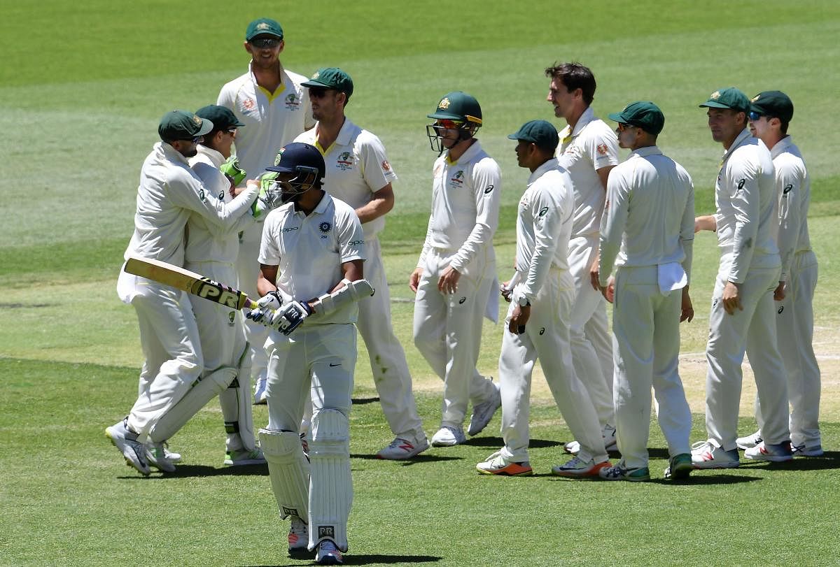 Batsman Ishant Sharma walks back to the pavilion after his dismissal as Australian players celebrate during day five of the second Test cricket match between Australia and India in Perth on December 18, 2018. (Photo AFP)