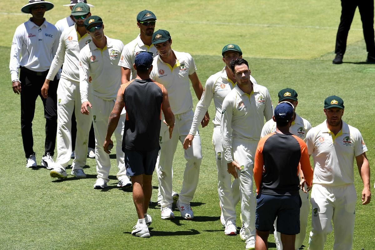 India's captian Virat Kohli (C) shakes hands with Australian players at the end of second Test cricket match between Australia and India in Perth on December 18, 2018. (Photo AFP)