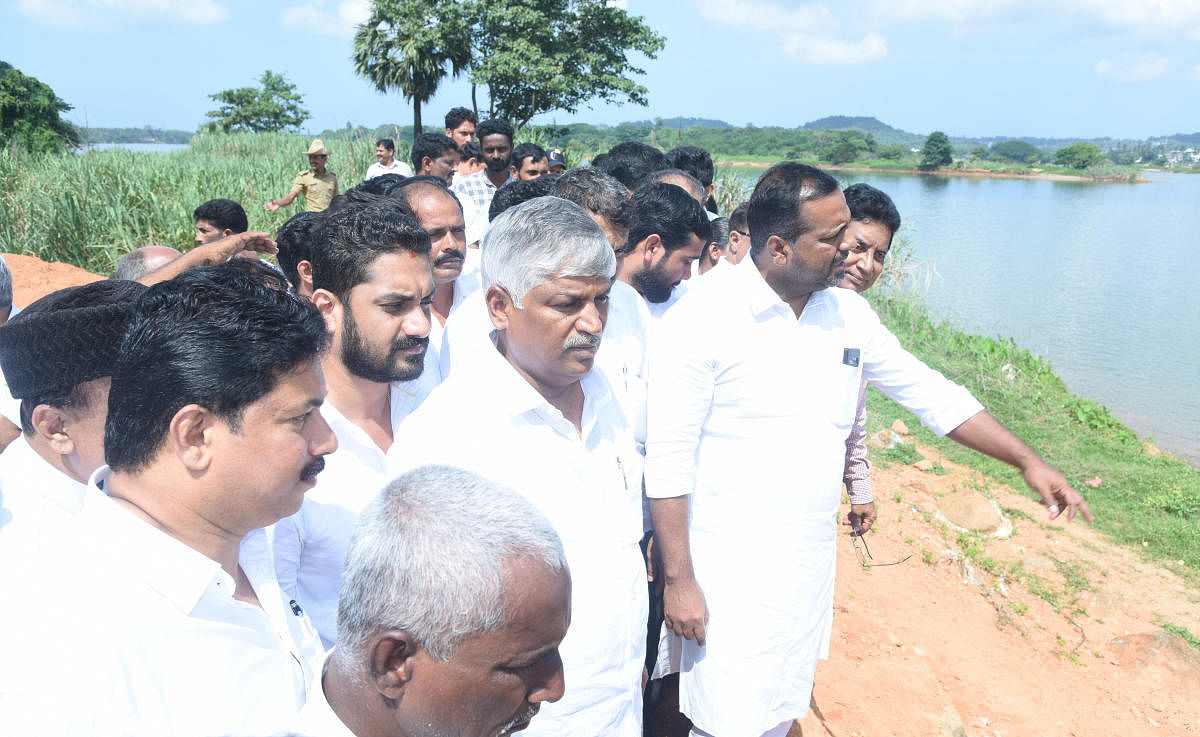 Minor Irrigation Minister C S Puttaraju and District In-Charge Minister U T Khader inspect the spot for the construction of a barrage-cum-bridge across River Nethravathi at Harekala on Friday.