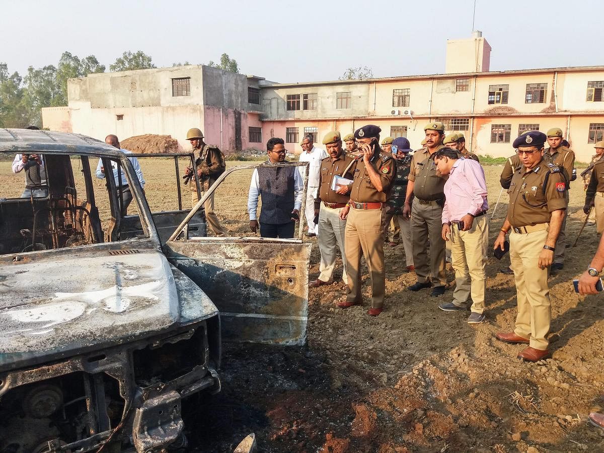 Policemen inspect after several vehicles were set on fire by a mob during a protest over the alleged illegal slaughter of cattle, in Bulandshahr, Monday, Dec. 03, 2018. According to Additional Director General of Meerut zone Prashant Kumar, protesters fro