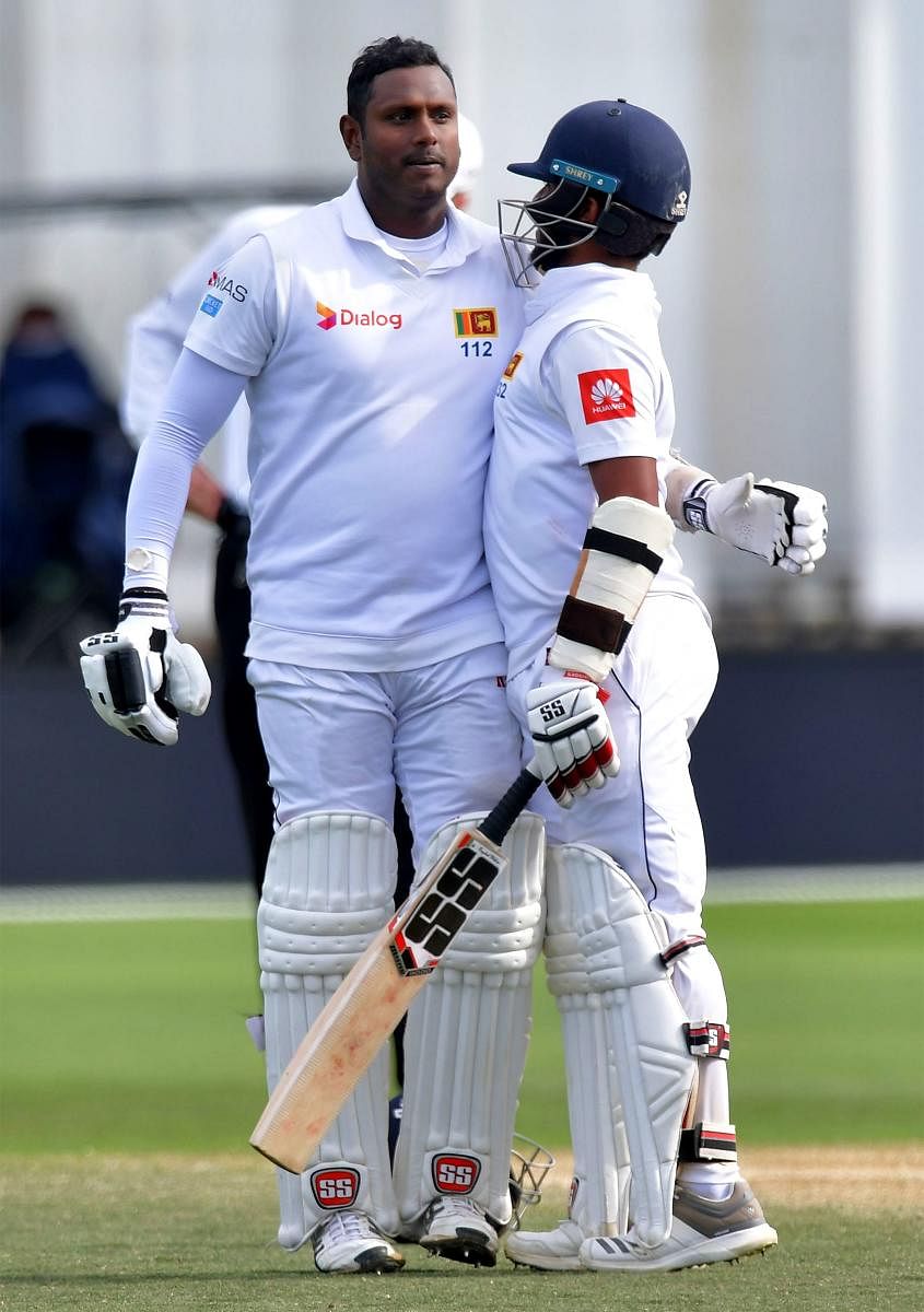 ROCK SOLID: Sri Lanka's Angleo Mathews celebrates his century with team-mate Kusal Mendis during the fourth day of the first Test against New Zealand in Wellington. AFP 
