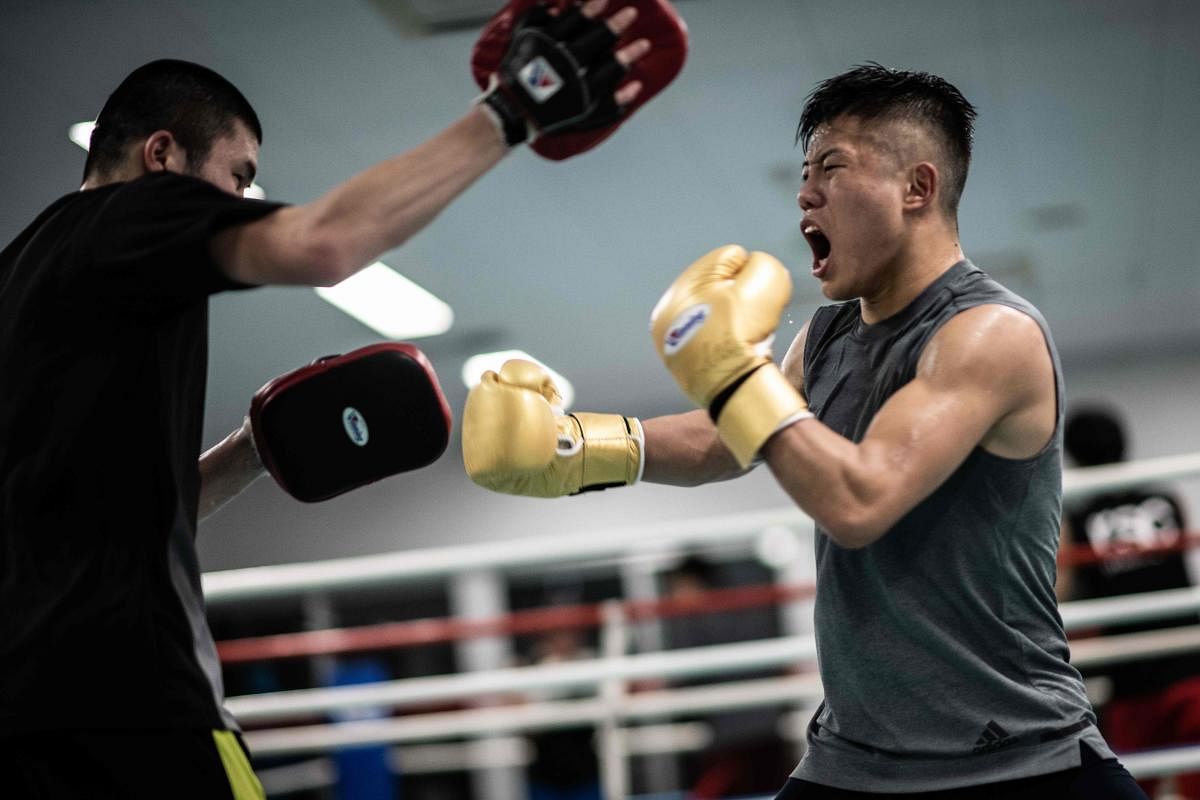 This picture taken on December 7, 2018 shows Yudai Shigeoka (R), captain of the Takushoku University boxing team, attending a training session at the university in Hachioji. - The International Olympic Committee said this month it was suspending preparati