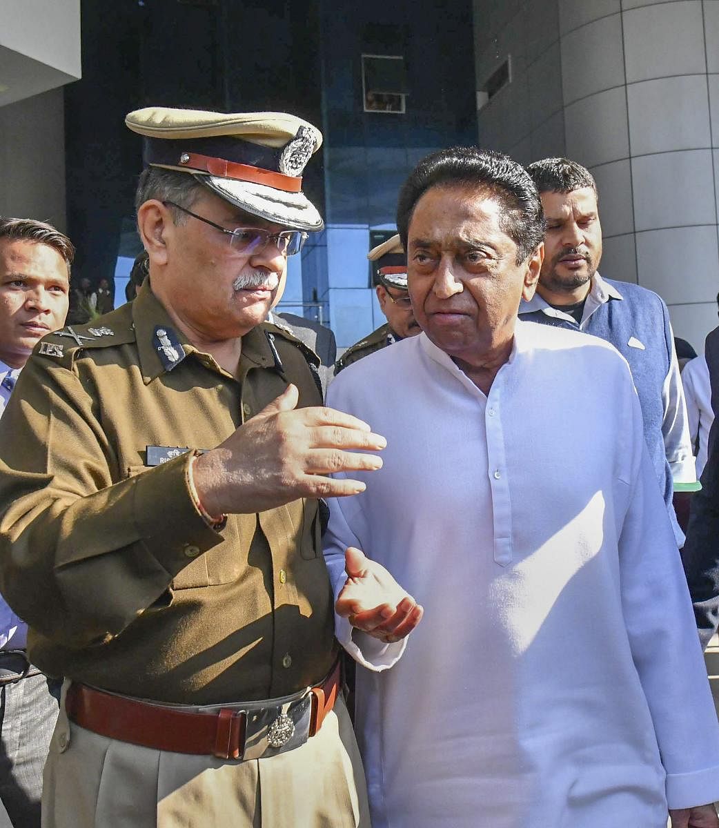 Madhya Pradesh Chief Minister Kamal Nath with DGP Rishi Kumar Shukla after meeting with senior police officials at the police hedquarters in Bhopal on Wednesday. PTI
