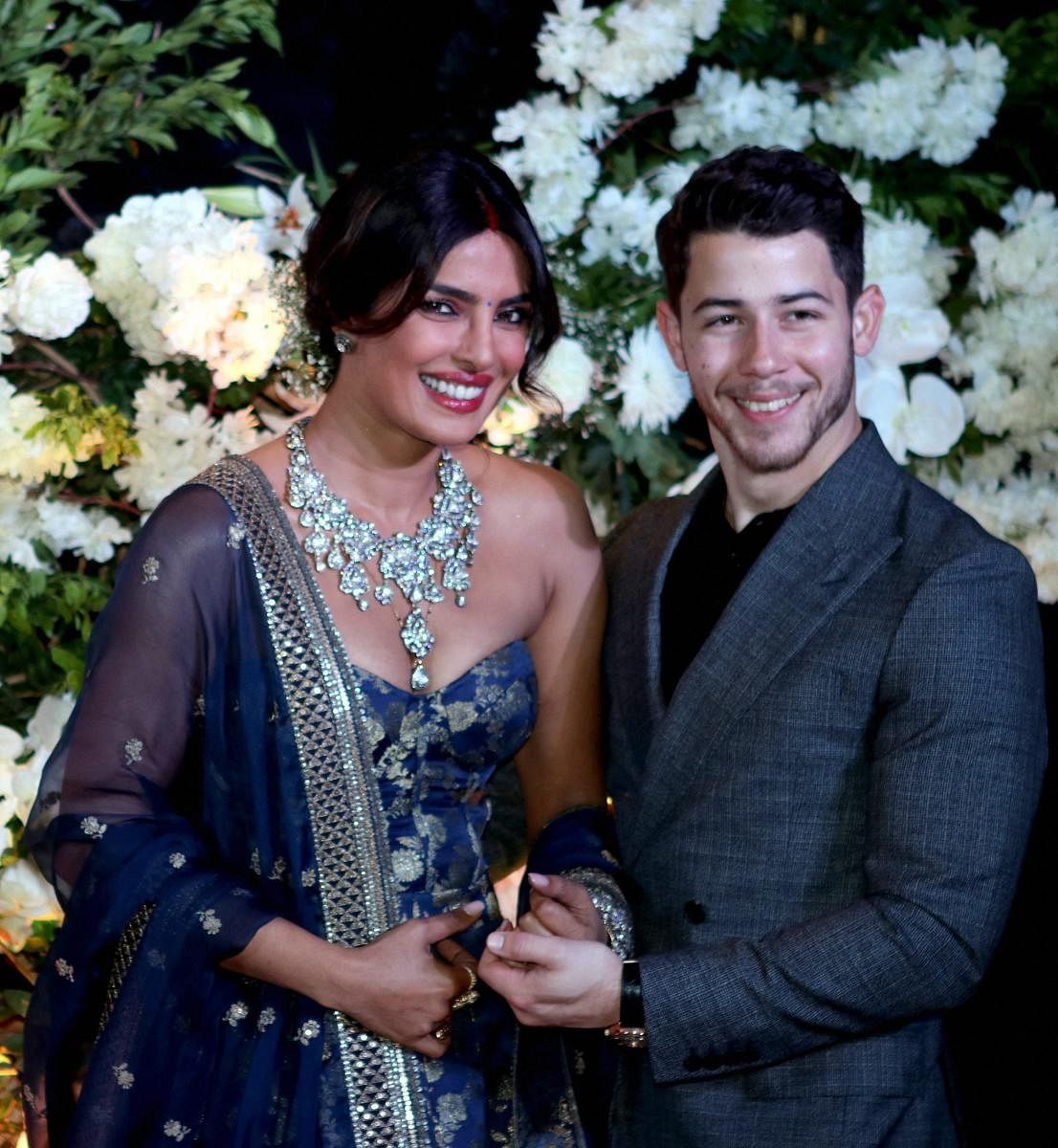 Bollywood actor Priyanka Chopra and American singer Nick Jonas pose for photos during their wedding reception Party in Mumbai on December 19, 2018. (PTI Photo)