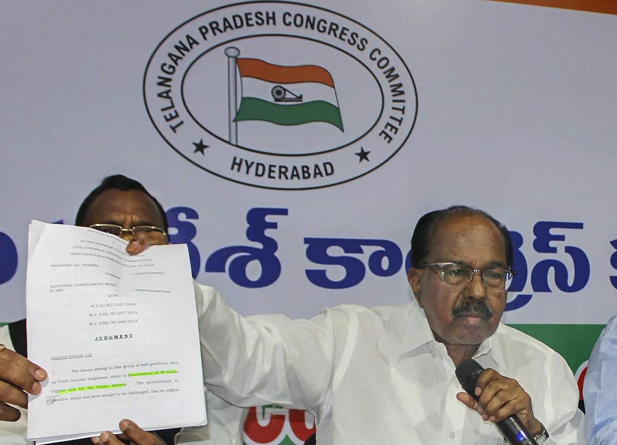 Parliamentary Standing Committee Chairman Veerappa Moily shows Supreme Court's order copy regarding Rafale Deal during a press conference, in Hyderabad. (PTI Photo)
