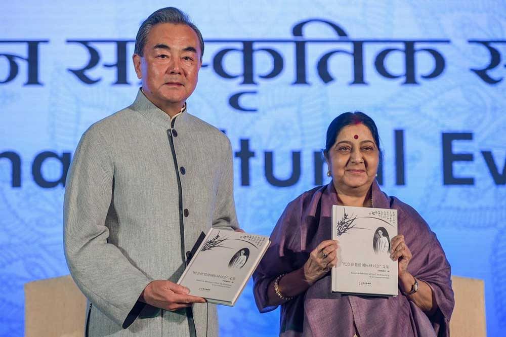 Union External Affairs Minister Sushma Swaraj and her Chinese counterpart Wang Yi release a book during the India-China Cultural Evening, at Pravasi Bhartiya Kendra in New Delhi. PTI Photo