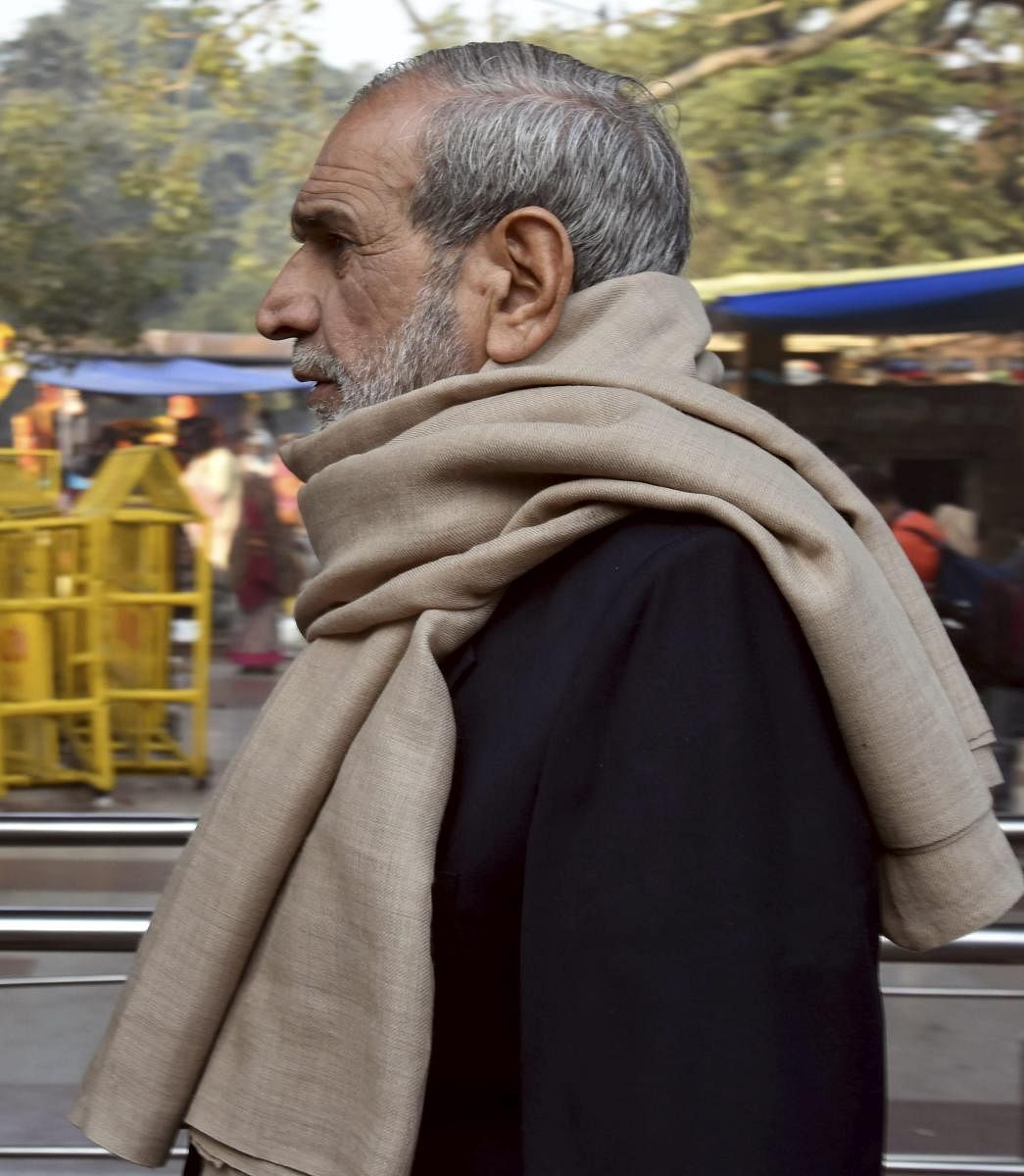 Congress leader Sajjan Kumar leaves after offering prayers at Hanuman temple in Connaught Place, in New Delhi. PTI