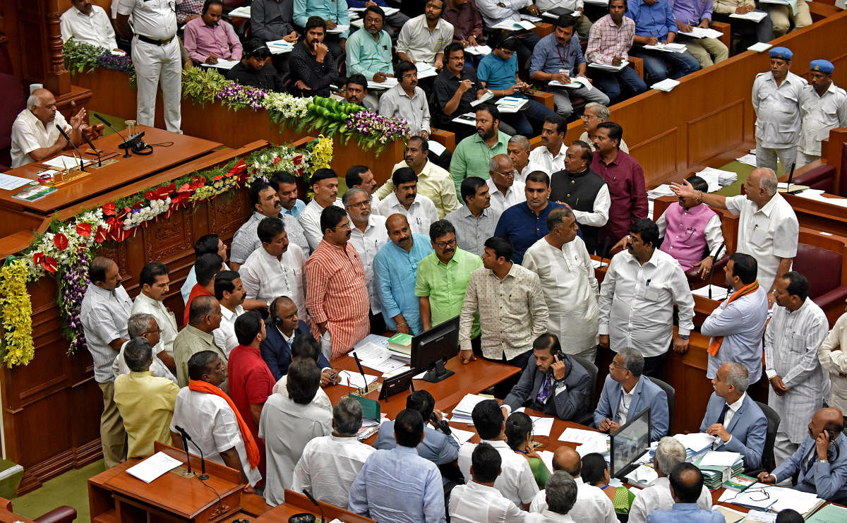 BJP leaders stage a protest in the Assembly in Belagavi on Thursday demanding farm loan waiver. DH photo/M S Manjunath