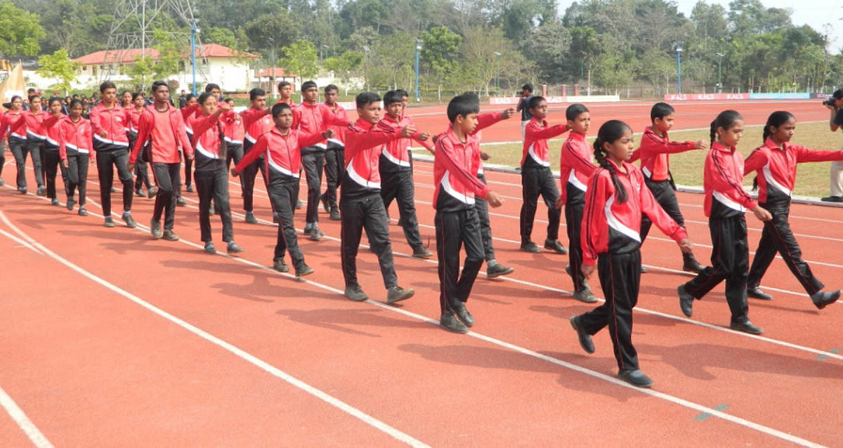 Participants take part in a march past at School Track and Field Championship, organised by Ashwini Sports Foundation, at CALS School grounds in Gonikoppa on Thursday.